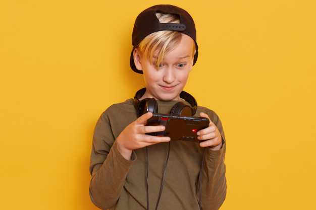 emotional-active-little-boy-with-blond-hair-carrying-his-finger-screen-smartphone-while-playing-his-favorite-online-game_176532-10126