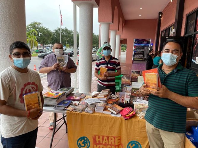 left_to_right_bipul_ramchand_mohan_nayan_and_bonkim_share_prabhupadas_books_at_a_monthly_sankirtan_festival